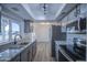 Modern kitchen with granite countertops, stainless steel appliances, and stylish gray cabinetry at 2833 W Marlette Ave, Phoenix, AZ 85017