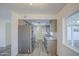 Spacious kitchen with gray cabinets, stainless steel appliances, granite countertops, and new gray flooring at 2833 W Marlette Ave, Phoenix, AZ 85017