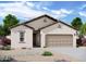 Charming single-story home with a tan stucco exterior, tile roof, and a two-car garage in a well landscaped community at 29761 N Oak Dr, Florence, AZ 85132