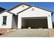 Spacious two-car garage with an open door and freshly poured concrete driveway, awaiting your personal touches at 29761 N Oak Dr, Florence, AZ 85132