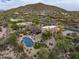 Majestic aerial view of the property nestled in the desert landscape, showcasing the pool and mountains beyond at 30330 N 77Th Pl, Scottsdale, AZ 85266