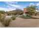 Lush backyard with a pool, putting green, and Adirondack chairs, ideal for outdoor relaxation and entertainment at 30330 N 77Th Pl, Scottsdale, AZ 85266