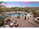 Aerial view of the private backyard featuring a pool, spa, fireplace, and comfortable outdoor seating at 30330 N 77Th Pl, Scottsdale, AZ 85266