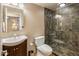 Modern bathroom featuring a glass shower with stylish tile and a contemporary sink and vanity at 30330 N 77Th Pl, Scottsdale, AZ 85266