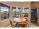 Bright breakfast nook featuring views of the backyard, custom wine refrigerator, and breakfast table at 30330 N 77Th Pl, Scottsdale, AZ 85266