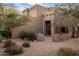 Southwestern-style home with desert landscaping and a private entrance, showcasing its unique architectural charm at 30330 N 77Th Pl, Scottsdale, AZ 85266