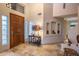 Bright foyer with travertine floors, niche details, and a wood front door with glass block side panels at 30330 N 77Th Pl, Scottsdale, AZ 85266
