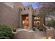 Inviting front entrance with desert landscaping, stone accents, and a warm, welcoming ambiance at 30330 N 77Th Pl, Scottsdale, AZ 85266