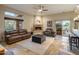 Bright living room featuring a stone fireplace, comfortable seating, and access to an outdoor patio at 30330 N 77Th Pl, Scottsdale, AZ 85266