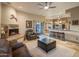 Open concept living room with travertine floors, stone fireplace, and easy access to the outdoor patio at 30330 N 77Th Pl, Scottsdale, AZ 85266