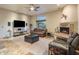 Spacious living room with stone fireplace, comfortable seating, and modern entertainment center at 30330 N 77Th Pl, Scottsdale, AZ 85266