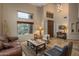 Open living room with high ceilings, travertine floors, and large windows offering desert views at 30330 N 77Th Pl, Scottsdale, AZ 85266