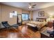 Bright main bedroom with hardwood floors, a window bench, and a comfortable queen-sized bed at 30330 N 77Th Pl, Scottsdale, AZ 85266