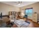 Inviting home office with hardwood floors, large window views, bookshelves, and a computer workstation at 30330 N 77Th Pl, Scottsdale, AZ 85266