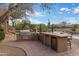 Outdoor kitchen featuring stainless steel appliances and a large counter area at 30330 N 77Th Pl, Scottsdale, AZ 85266