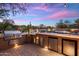 Outdoor kitchen with a grill and cooler for backyard enjoyment with a beautiful colorful sky at 30330 N 77Th Pl, Scottsdale, AZ 85266
