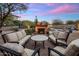 Backyard with fireplace and couches surrounding it with a pool nearby, perfect for entertaining and relaxing at 30330 N 77Th Pl, Scottsdale, AZ 85266
