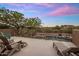 Relaxing patio with comfortable seating overlooking the pool, desert landscape, and sunset skies at 30330 N 77Th Pl, Scottsdale, AZ 85266