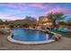 A large pool with rock features and Baja shelf; outdoor lounge chairs and seating with desert landscaping at 30330 N 77Th Pl, Scottsdale, AZ 85266