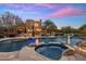Gorgeous backyard with a large pool and spa, an outdoor kitchen and beautiful desert landscaping at 30330 N 77Th Pl, Scottsdale, AZ 85266