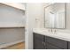 Modern bathroom featuring a grey vanity and a large walk-in closet at 3202 E Orange Dr, Phoenix, AZ 85018