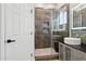 Modern bathroom showcasing a large glass shower and floating double sink vanity at 3202 E Orange Dr, Phoenix, AZ 85018