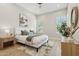 Bright bedroom with a white bed frame, wood floors, and plantation shutters at 3202 E Orange Dr, Phoenix, AZ 85018
