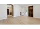 Spacious bedroom featuring light wood floors, walk-out door, and a custom built-in bookcase at 3202 E Orange Dr, Phoenix, AZ 85018