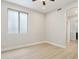 Neutral bedroom with ceiling fan and a hallway to a bathroom at 3202 E Orange Dr, Phoenix, AZ 85018