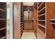 Spacious walk-in closet with custom wood shelving and hanging rods at 3202 E Orange Dr, Phoenix, AZ 85018