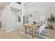 Bright dining room with a wood table, six chairs, light floors, and tall ceilings at 3202 E Orange Dr, Phoenix, AZ 85018