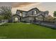 Stunning two-story home showcasing lush green lawn, and three-car garage, creating an inviting curb appeal at 3202 E Orange Dr, Phoenix, AZ 85018