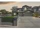Elegant two-story home showcasing a wide driveway, lush lawn, and a three-car garage at 3202 E Orange Dr, Phoenix, AZ 85018