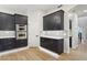 Modern kitchen with under-cabinet lighting, stainless steel appliances, and dark cabinets at 3202 E Orange Dr, Phoenix, AZ 85018