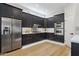 Updated kitchen with stainless steel appliances, dark cabinets, and modern backsplash at 3202 E Orange Dr, Phoenix, AZ 85018