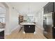 Spacious kitchen with an island, stone fireplace, and stainless steel refrigerator at 3202 E Orange Dr, Phoenix, AZ 85018