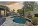 Gorgeous pool area with custom stonework, built-in BBQ, and lush landscaping, perfect for outdoor gatherings at 3202 E Orange Dr, Phoenix, AZ 85018
