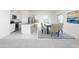 Bright open-concept kitchen and dining area featuring modern appliances and stylish, comfortable seating at 32202 N Knauss Ln, San Tan Valley, AZ 85143