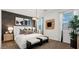 Elegant bedroom with a black accent wall, decorative art, and a luxurious, inviting bed at 35556 N Common Ct, San Tan Valley, AZ 85140