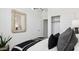Bright bedroom featuring a woven mirror, sleek closet doors, and plush bedding at 35556 N Common Ct, San Tan Valley, AZ 85140
