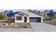 New construction home with a well-manicured xeriscaped front yard, 2-car garage and mountain backdrop at 35556 N Common Ct, San Tan Valley, AZ 85140