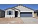 Charming single-story home featuring a gray garage door and inviting entrance with blue window shutters at 35556 N Common Ct, San Tan Valley, AZ 85140