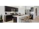 Bright kitchen features dark cabinetry, stainless steel appliances, and a marble topped island at 35556 N Common Ct, San Tan Valley, AZ 85140