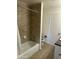 Bathroom featuring a shower and bathtub combination with ceramic tile surround, white fixtures and tile floors at 3608 W Hazelwood St, Phoenix, AZ 85019
