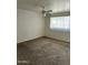 A bedroom featuring a ceiling fan, brick accent wall, carpet and a window with blinds at 3608 W Hazelwood St, Phoenix, AZ 85019
