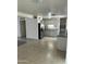 Open-concept kitchen featuring neutral cabinets, stainless steel refrigerator, and tile flooring at 3608 W Hazelwood St, Phoenix, AZ 85019