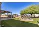 Landscaped backyard with a fire pit and outdoor seating area surrounded by green grass at 3720 E Vista Grande --, San Tan Valley, AZ 85140