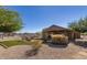 Large backyard featuring a fire pit, covered patio, lush turf, and low-maintenance landscaping at 3720 E Vista Grande --, San Tan Valley, AZ 85140