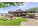 Picturesque backyard with a fire pit, covered patio, lush turf, and easy-care landscaping at 3720 E Vista Grande --, San Tan Valley, AZ 85140