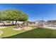 Inviting backyard oasis featuring a fire pit, seating, lush landscaping, and in-ground pool at 3720 E Vista Grande --, San Tan Valley, AZ 85140